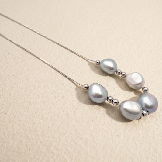 Pearl necklace on a beige background