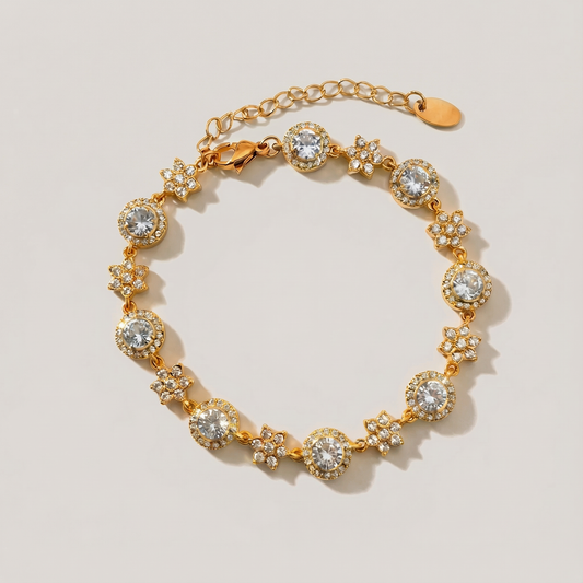 Gold bracelet with diamond-like stones on a light beige background