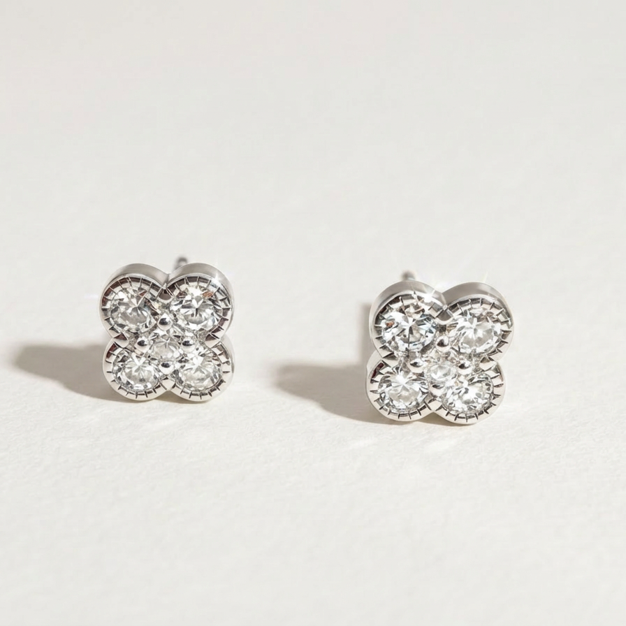 Clover Shine stud earrings in silver finish with cubic zirconia on a light background
