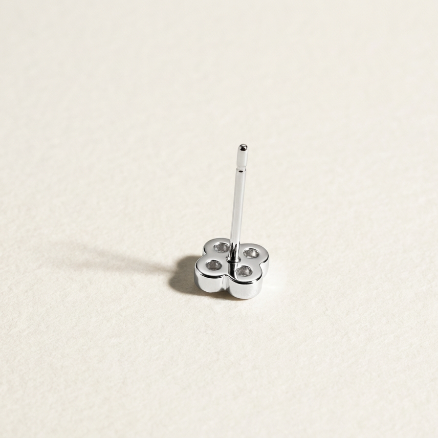 Back view of a single Clover Shine silver stud earring with post upright on a light background
