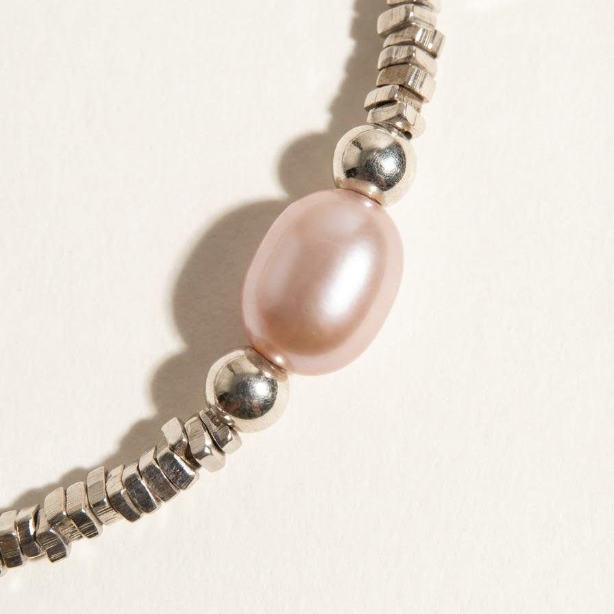 Close-up of a lavender baroque pearl and sterling silver beads on The Lavender Star bracelet