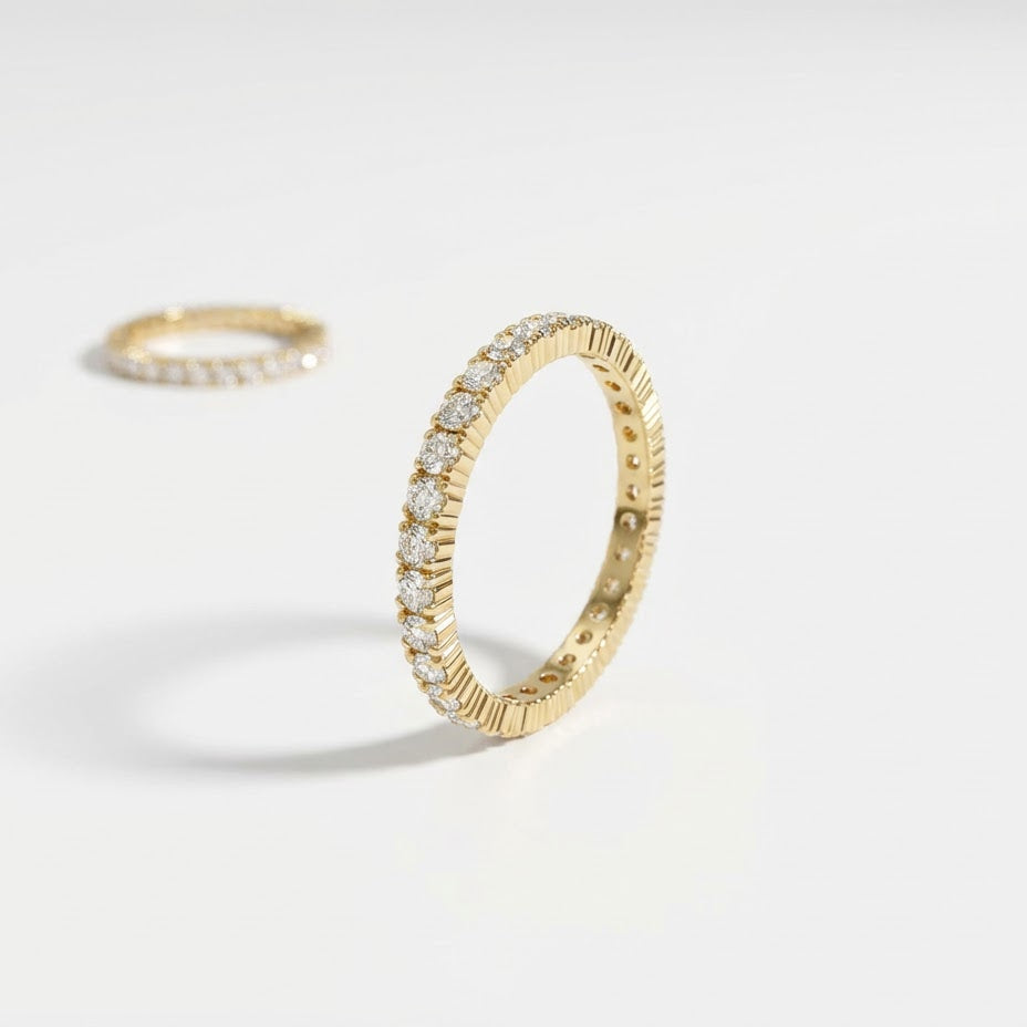 Close-up of the eternity ring from the Luna Duo Rings stackable set with clear cubic zirconia, shown upright on a light background