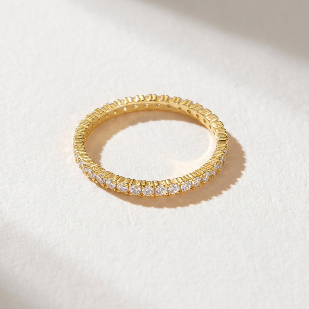 The eternity ring from the Luna Duo Rings stackable set with clear cubic zirconia shown on a light background