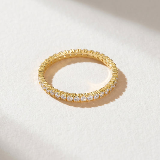 The eternity ring from the Luna Duo Rings stackable set with clear cubic zirconia shown on a light background