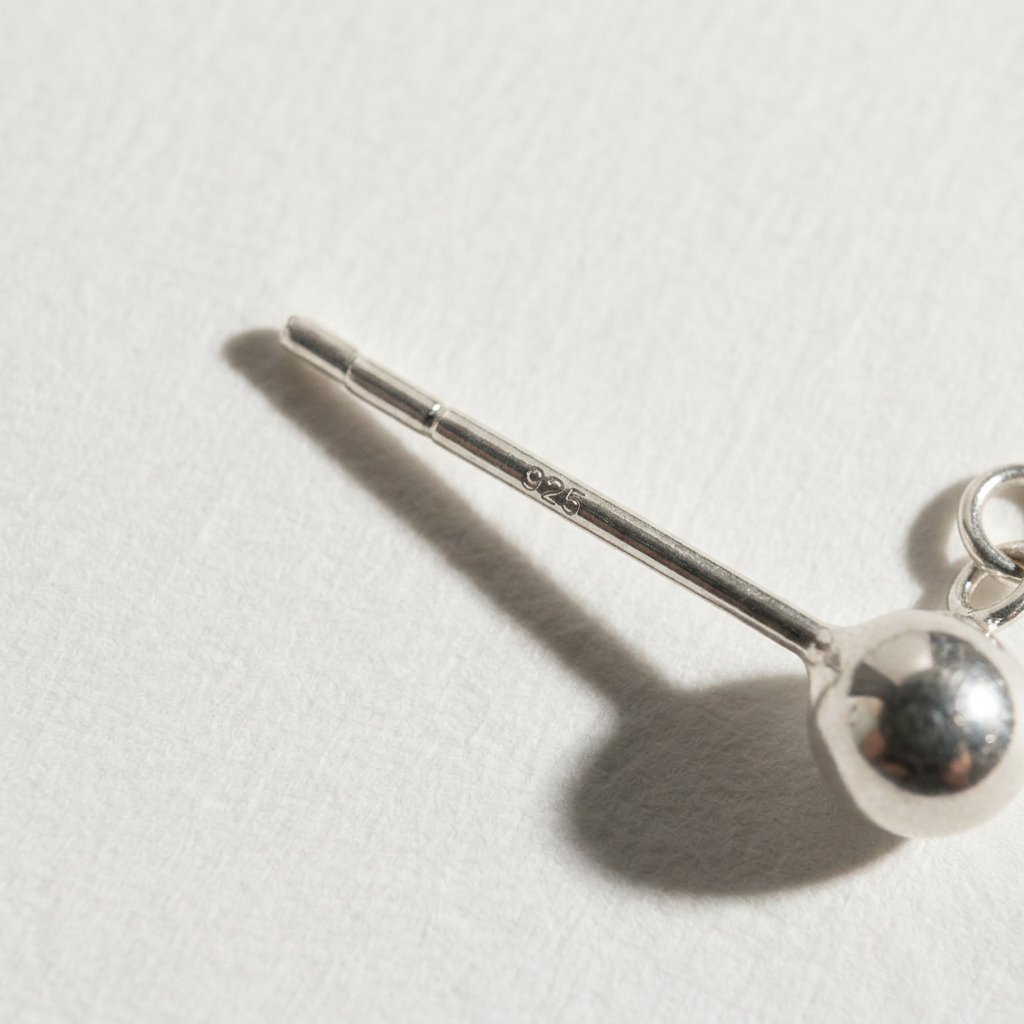 Close-up of The Ethereal Drop pearl drop earrings showing the S925 sterling silver post and ball stud detail