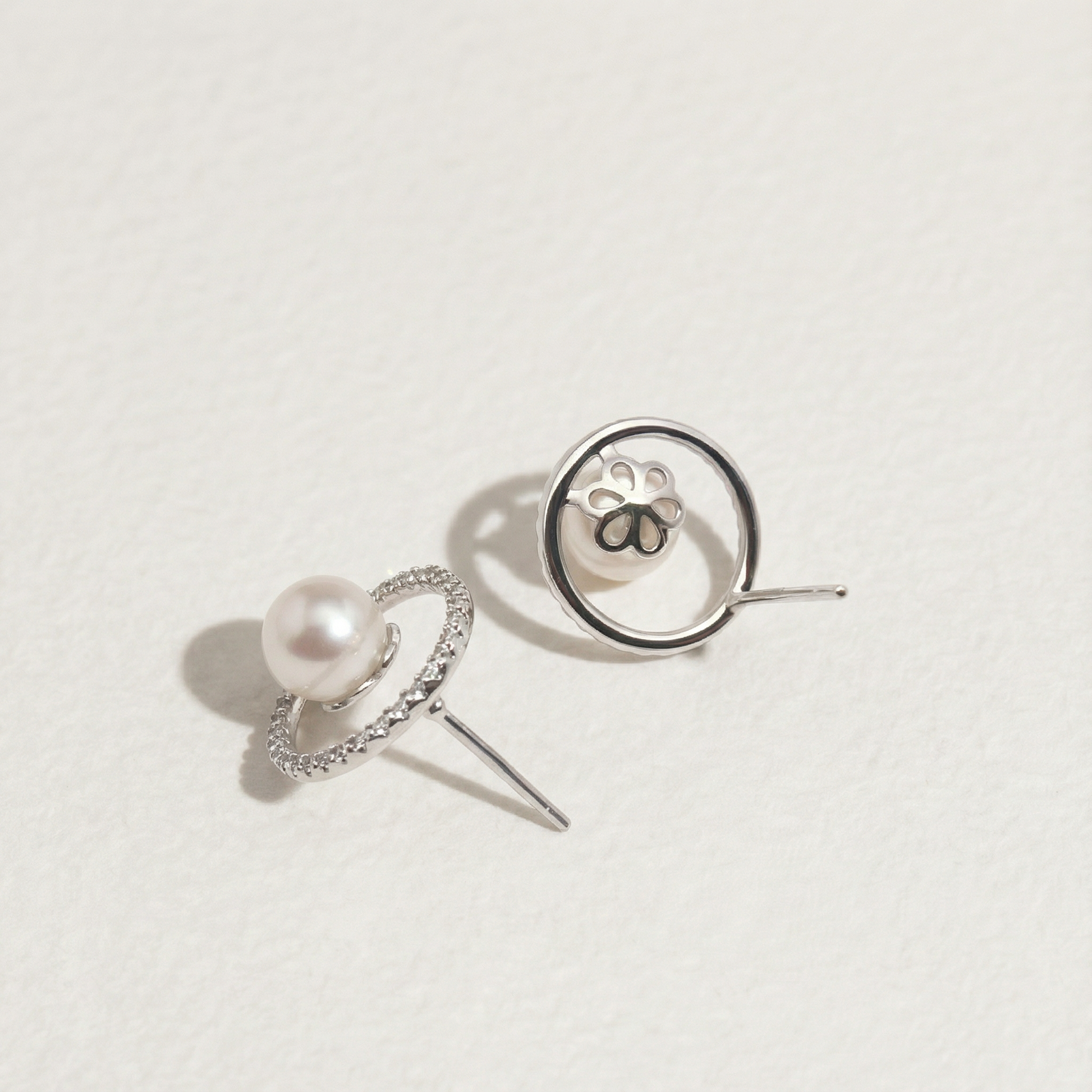 Back detail of The Halo Pearl zircon-set stud earrings showing the post, butterfly back, and underside of the pearl halo setting