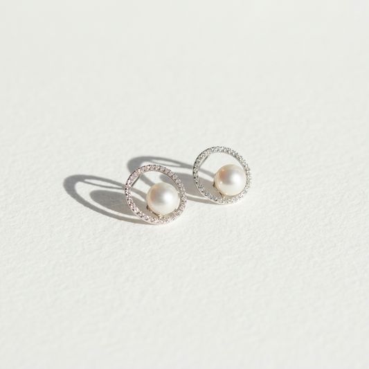 The Halo Pearl zircon-set stud earrings with freshwater pearls shown in angled view on a light background