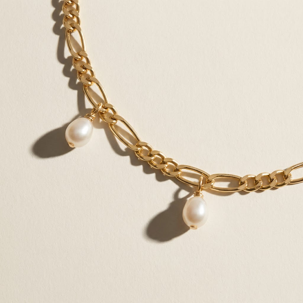 Close-up of The Halo Thread freshwater pearl bracelet in 18K gold-plated sterling silver, showing chain links and suspended freshwater pearl drops