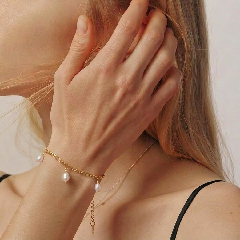 The Halo Thread freshwater pearl bracelet in 18K gold-plated sterling silver, styled on the wrist with suspended freshwater pearls