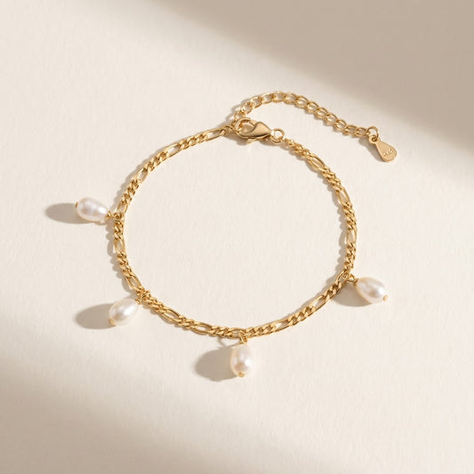 The Halo Thread freshwater pearl bracelet in 18K gold-plated sterling silver with suspended freshwater pearls, shown from above on a soft neutral background