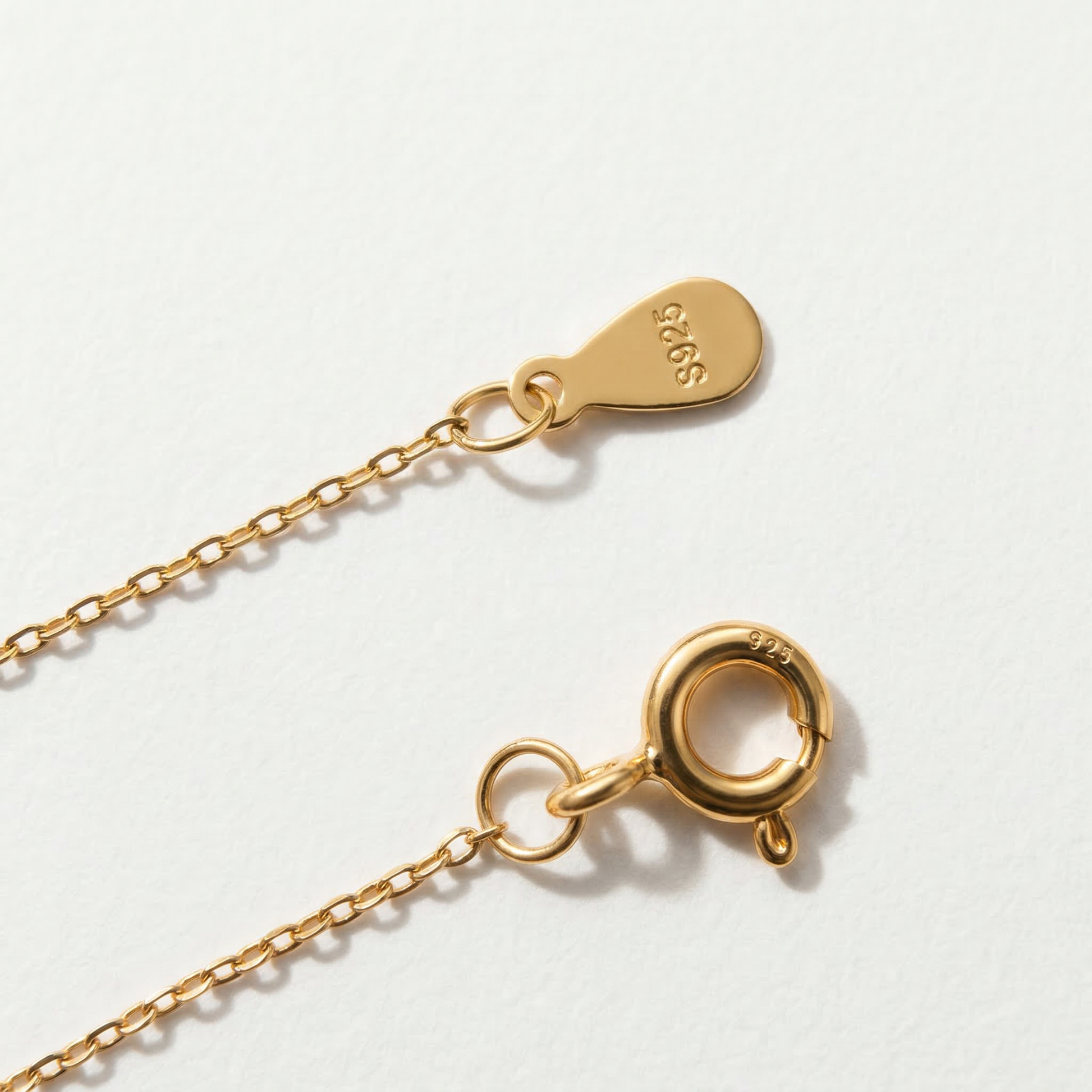 Clasp detail of The Keeper’s Whisper necklace showing the spring ring closure and S925 tag on a light background