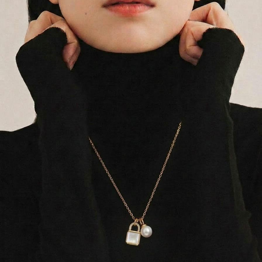 The Keeper’s Whisper necklace worn on the neck, featuring a mother-of-pearl lock pendant and freshwater pearl