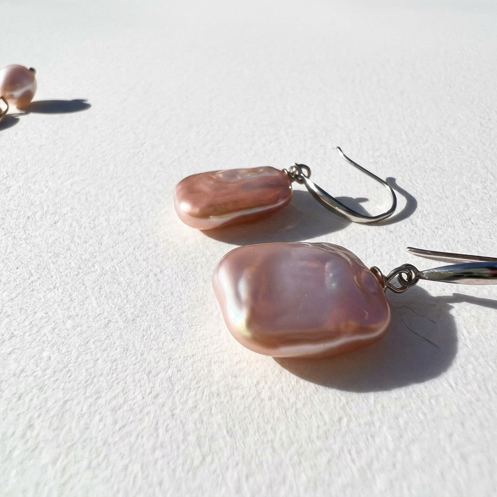 Close-up of The Lavender Geometric baroque pearl drop earrings showing the natural shape and lustre of the lavender pearls