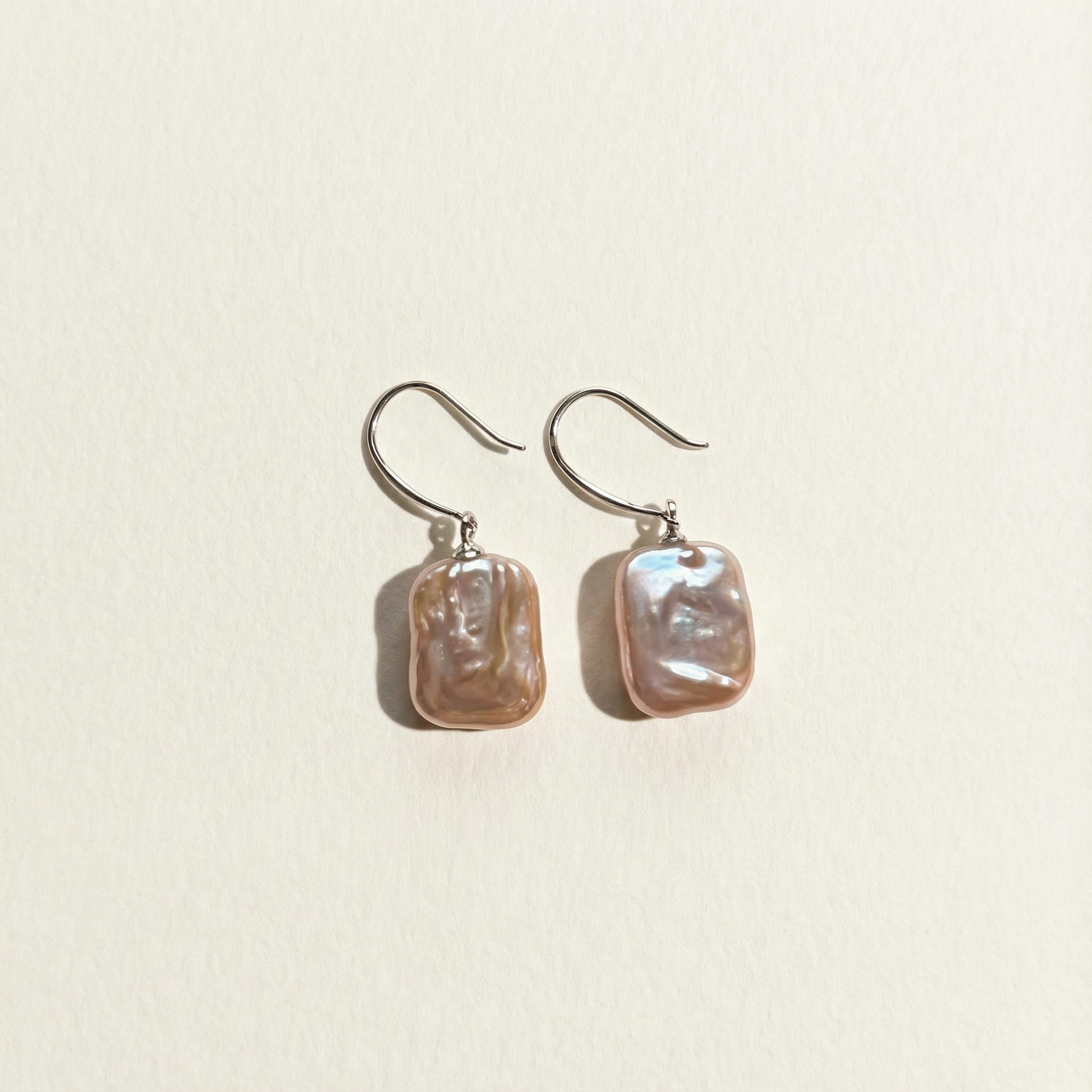 The Lavender Geometric baroque pearl drop earrings shown in full view on a light background