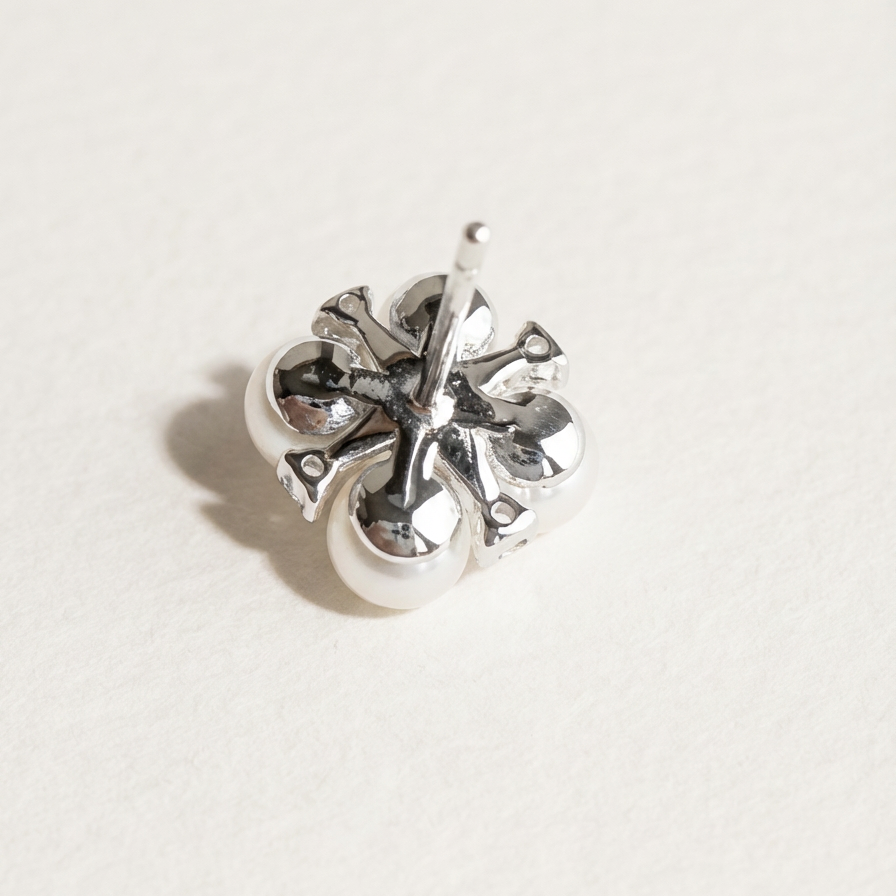 The Lucky Cluster clover pearl cluster stud earring shown from the back in sterling silver with a post fitting on a light grey background
