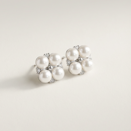 The Lucky Cluster clover pearl cluster stud earrings in sterling silver with freshwater pearls and cubic zirconia accents on a light grey background