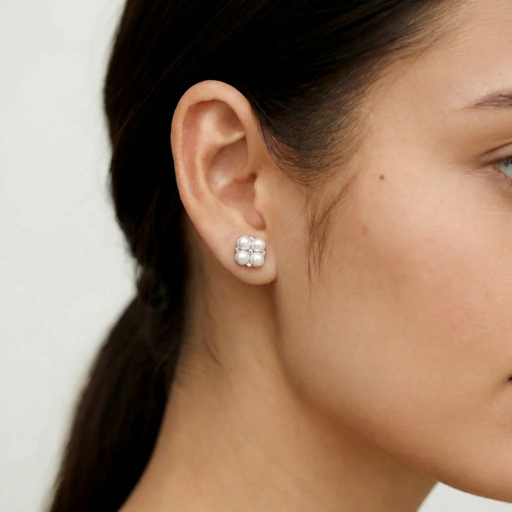 The Lucky Cluster clover pearl cluster stud earring worn on the ear in sterling silver with freshwater pearls and cubic zirconia accents