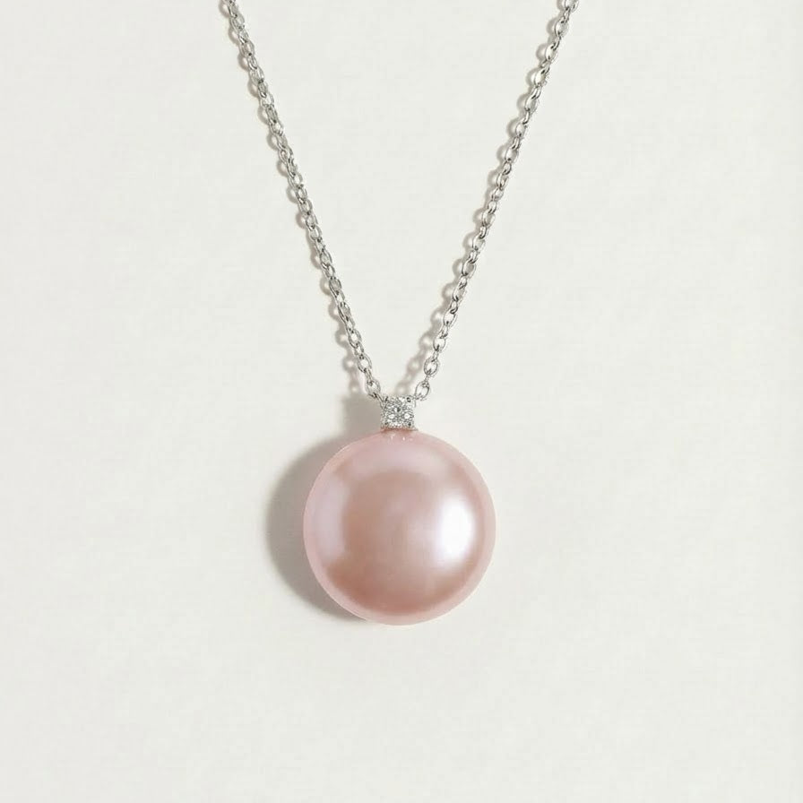 The Moondrop button pearl pendant necklace with a round baroque freshwater pearl on a light background
