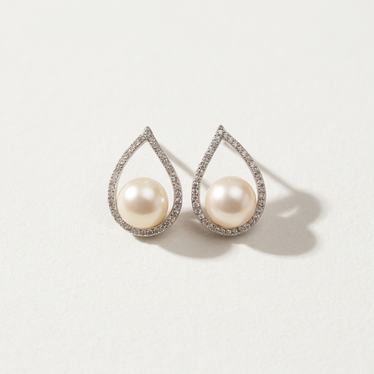 The Quiet Drop pearl zircon stud earrings with freshwater pearls in teardrop sterling silver settings shown on a light background