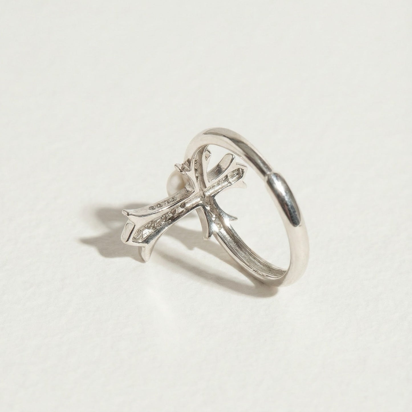 Back detail of The Sacred Glow pearl cross ring showing the underside of the pearl setting and cross structure