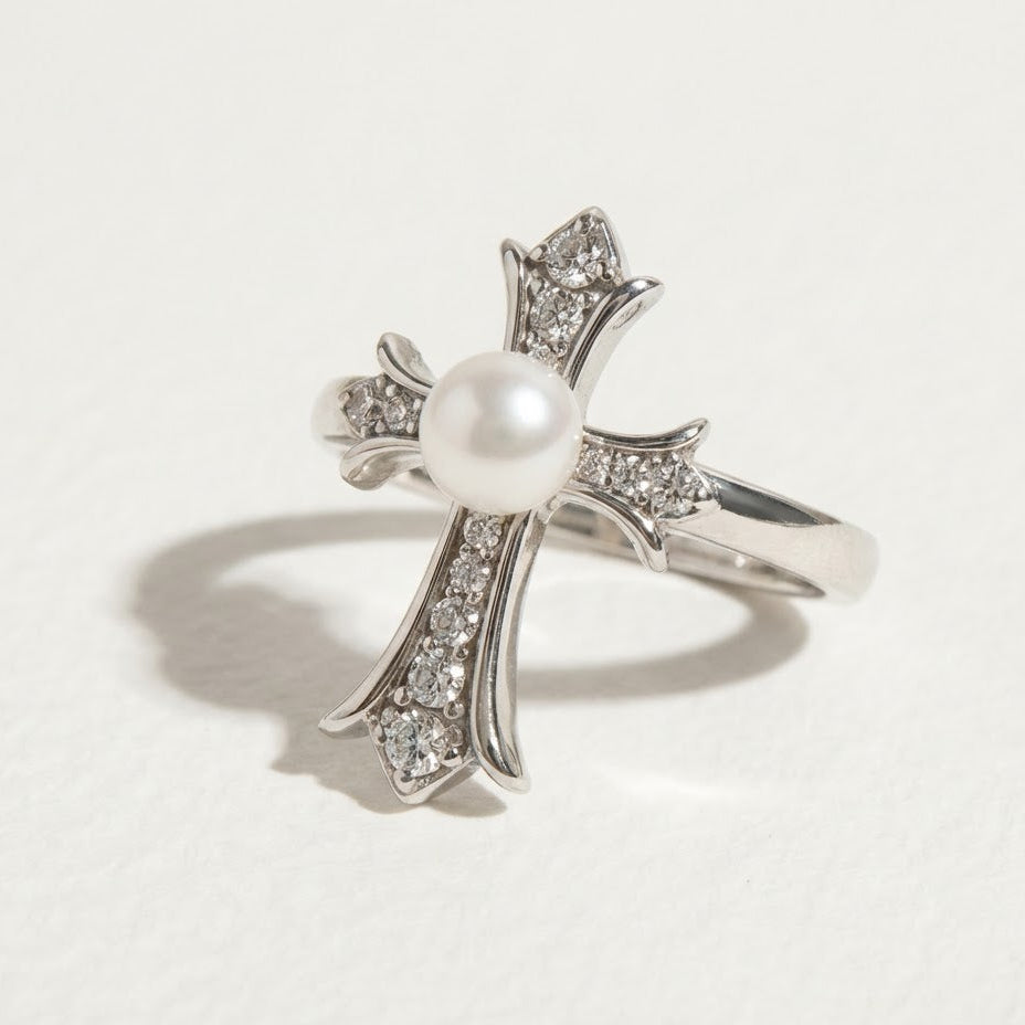 The Sacred Glow pearl cross ring with a freshwater pearl and zirconia shown on a light background