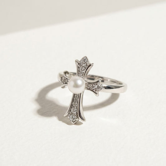 The Sacred Glow pearl cross ring in angled view with a freshwater pearl and zirconia