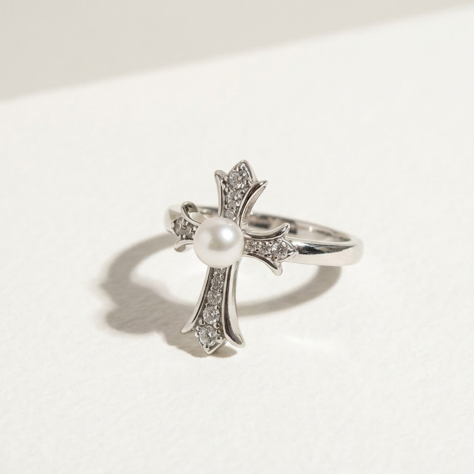 The Sacred Glow pearl cross ring in angled view with a freshwater pearl and zirconia