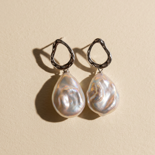 Close-up of The Silver Drift baroque pearl drop earrings in sterling silver with natural baroque freshwater pearls