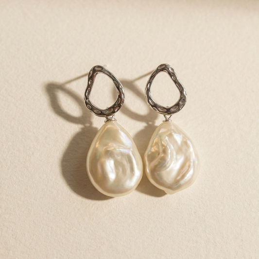 The Silver Drift baroque pearl drop earrings in sterling silver with natural baroque freshwater pearls, shown from the front