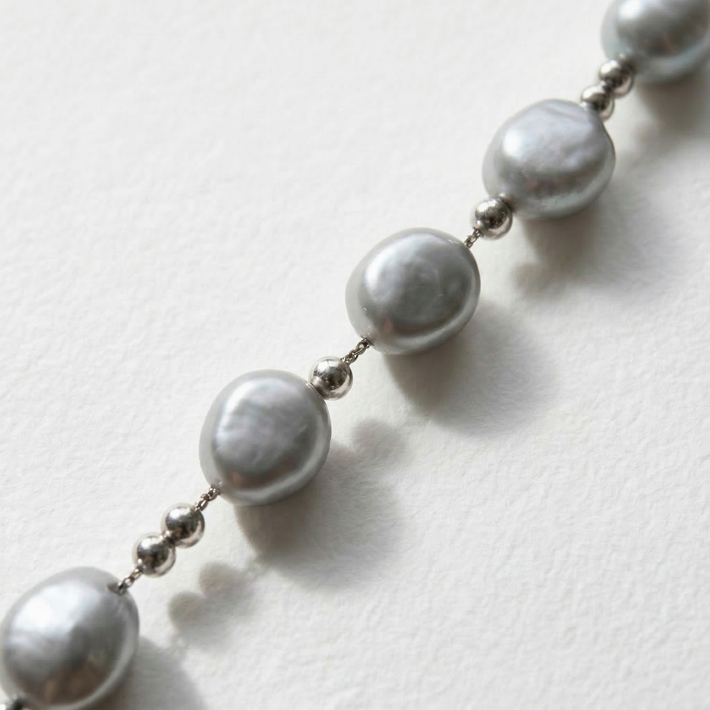 Close-up of the grey baroque pearls and sterling silver beads on The Silver Mist necklace