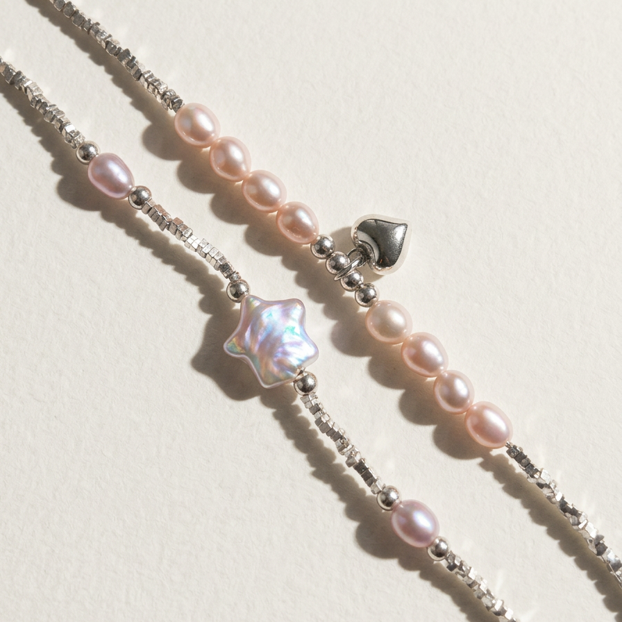 Close-up comparison of two sterling silver bracelets, one with a star-shaped pearl detail and one with peach freshwater pearls and a heart charm, on a light beige background