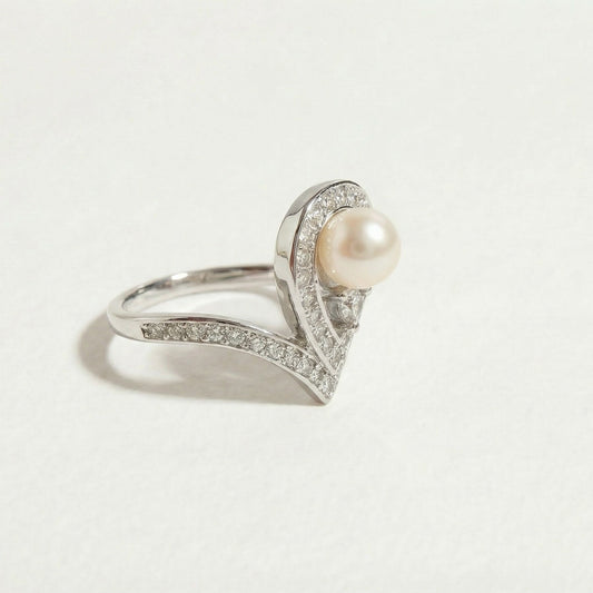 Close-up of The Sovereign Glow pearl tiara ring with a freshwater pearl and zirconia shown on a light background
