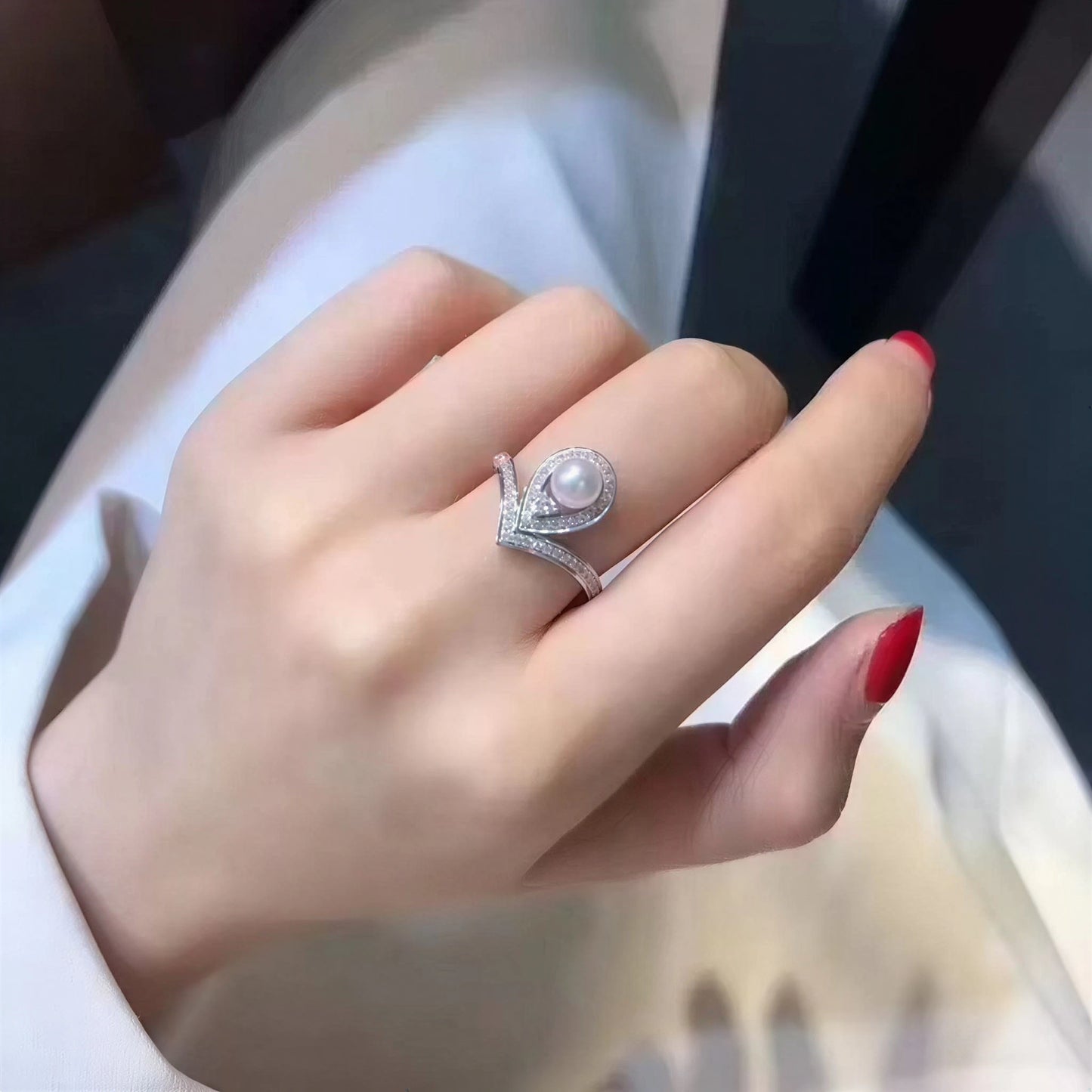 The Sovereign Glow pearl tiara ring with a freshwater pearl and zirconia worn on the hand in close-up