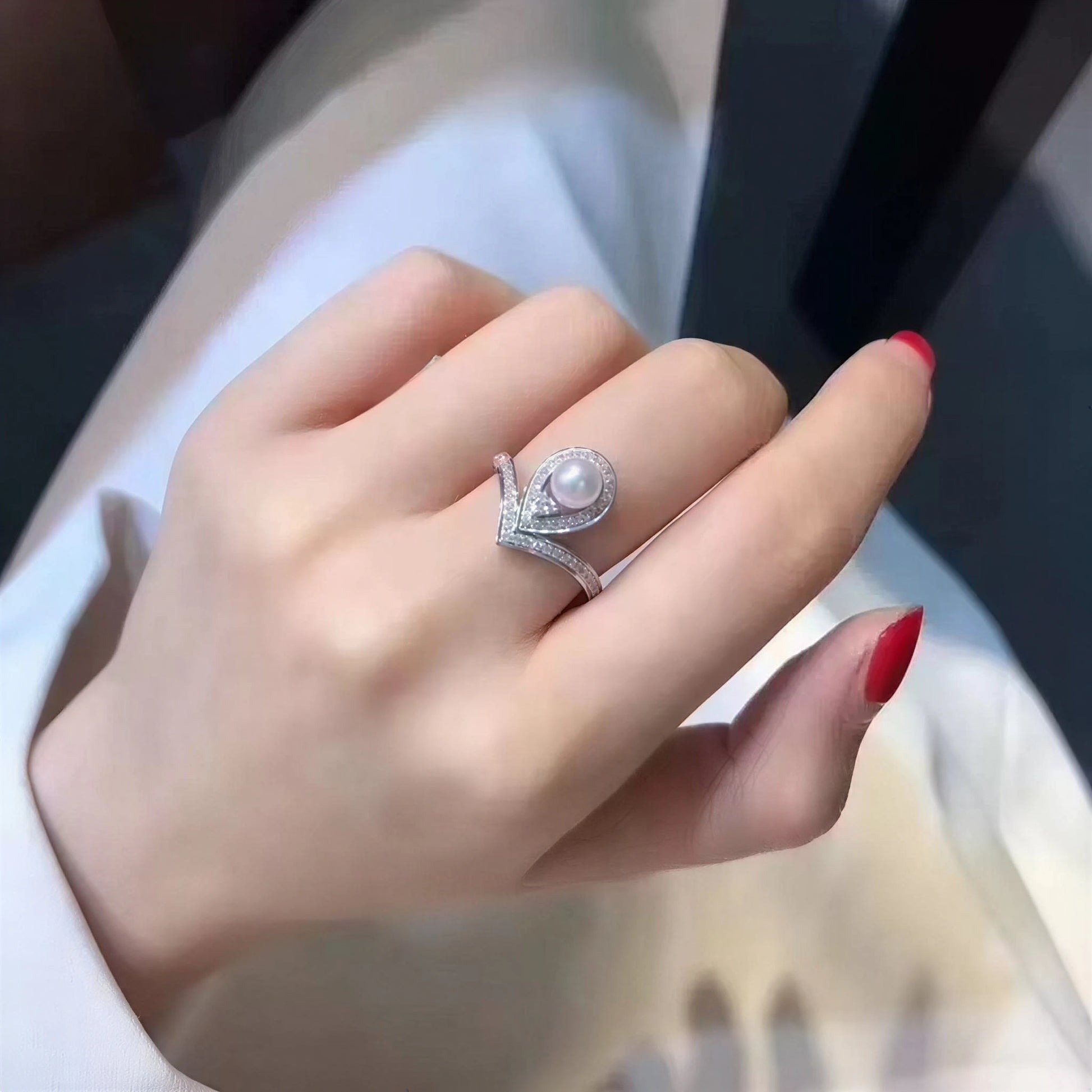 The Sovereign Glow pearl tiara ring with a freshwater pearl and zirconia worn on the hand in close-up