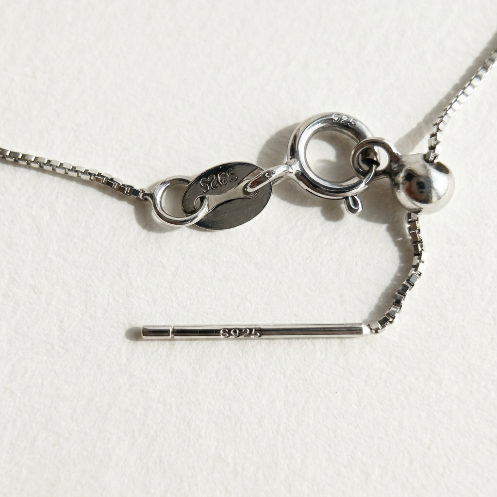 Clasp detail of The Stardust Path necklace showing the spring ring closure, sliding adjuster, and S925 markings