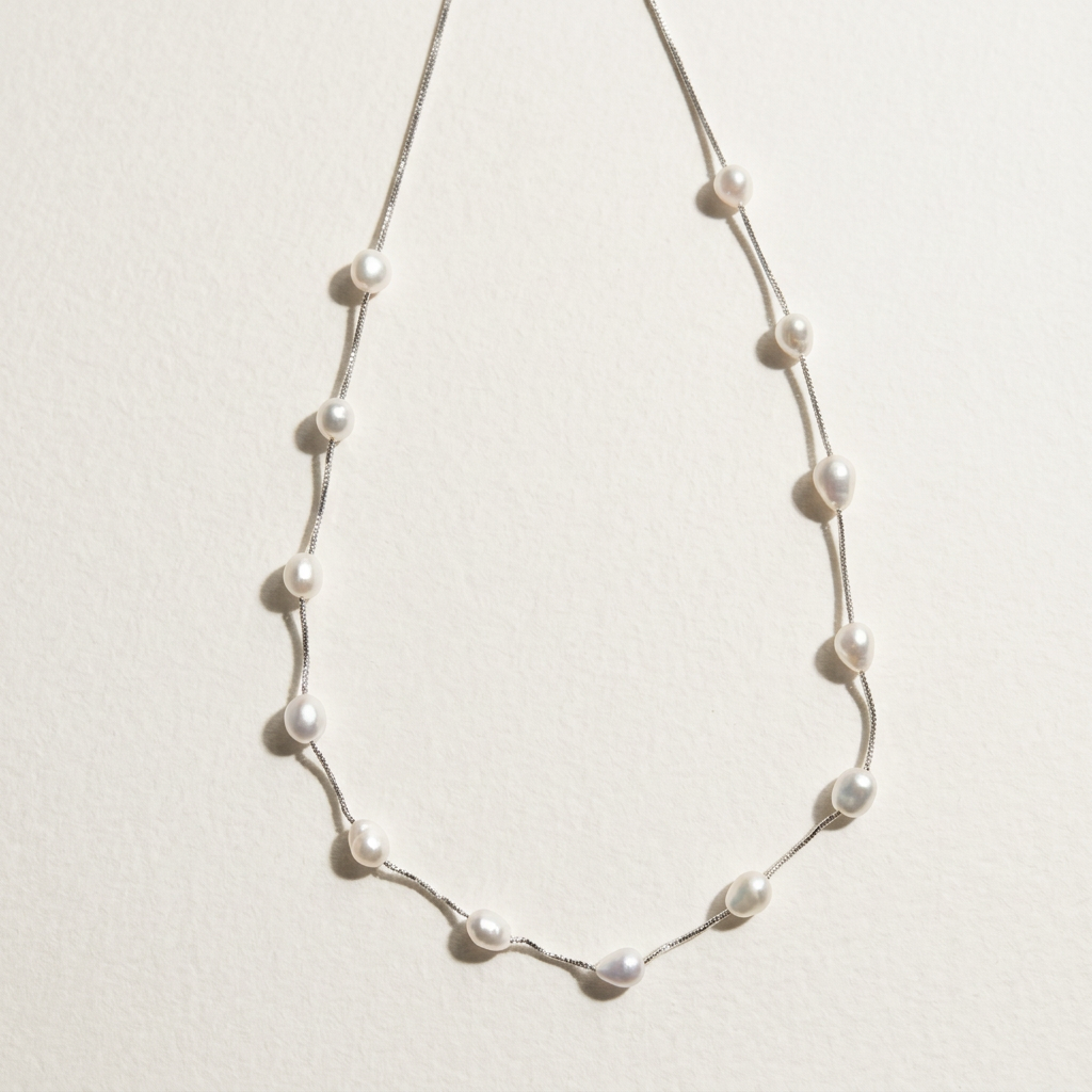 The Stardust Path irregular pearl station necklace shown on a light background