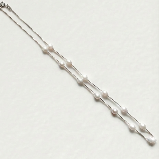 The Stardust Path necklace shown in full view with irregular natural pearls spaced along a sterling silver chain