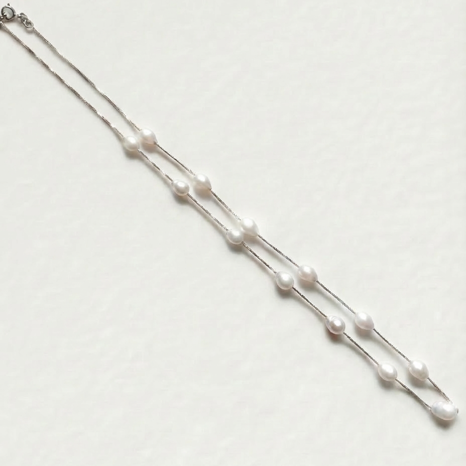 The Stardust Path necklace shown in full view with irregular natural pearls spaced along a sterling silver chain