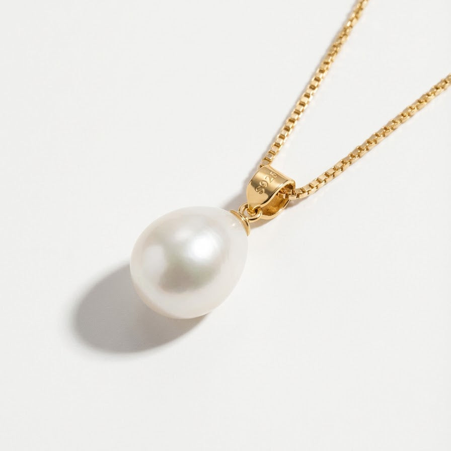 The Steady Pearl necklace in gold-plated sterling silver with a single baroque freshwater pearl on a light grey background