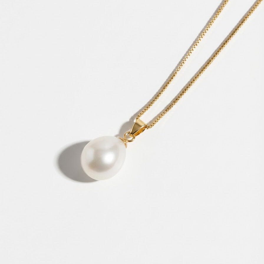 The Steady Pearl necklace in gold-plated sterling silver with a single baroque freshwater pearl on a light grey background