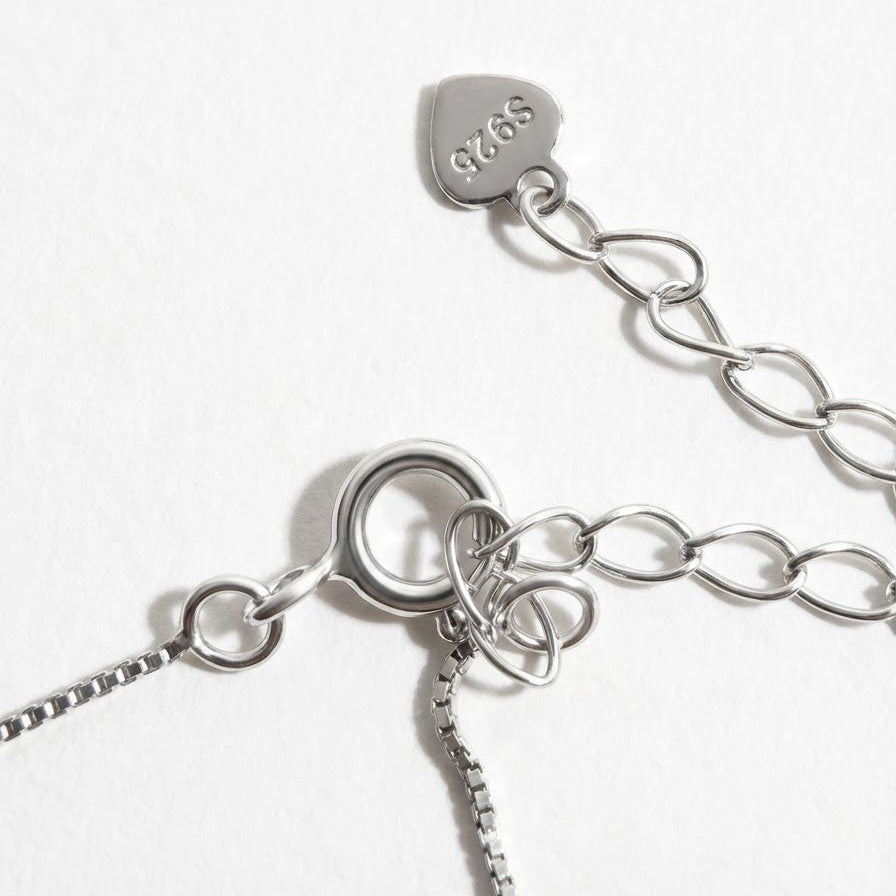 The Steady Pearl necklace clasp in sterling silver with extender chain and S925 tag on a light grey background