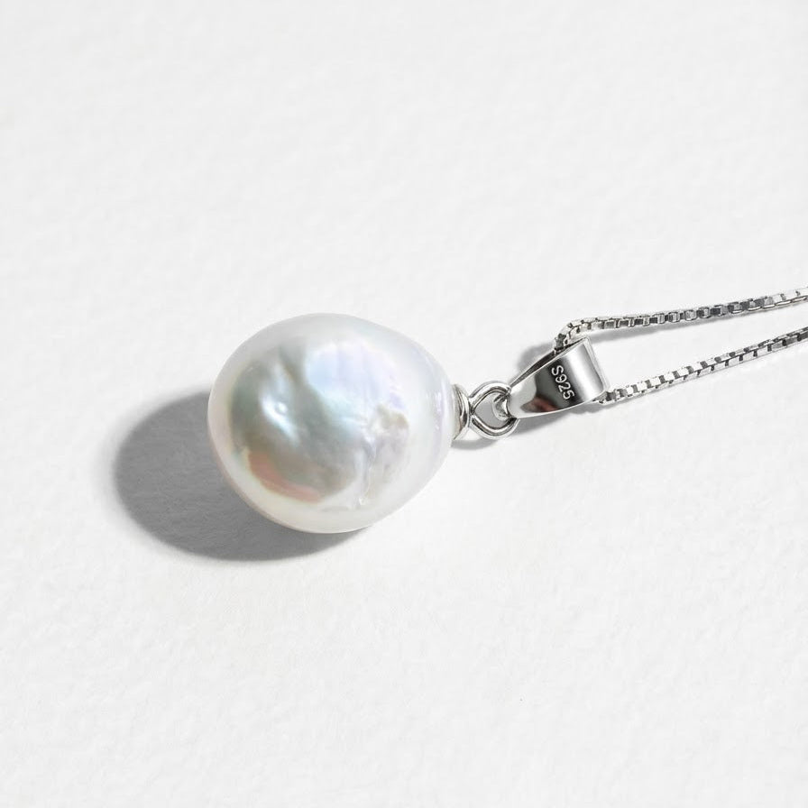 The Steady Pearl necklace in sterling silver with a single baroque freshwater pearl on a light grey background