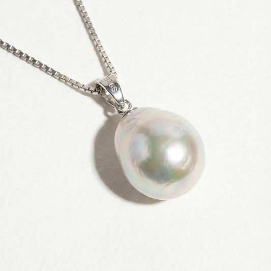 The Steady Pearl necklace in sterling silver with a single baroque freshwater pearl on a light grey background